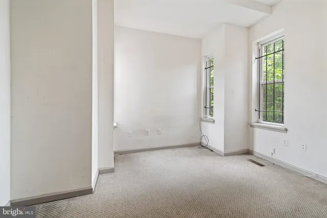 a room with a sink a vanity and window