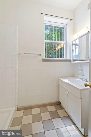 a bathroom with a sink a toilet and a shower
