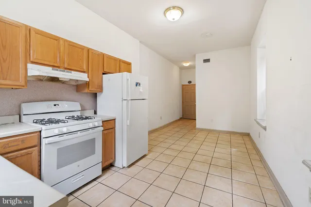 a kitchen with a stove top oven and cabinets