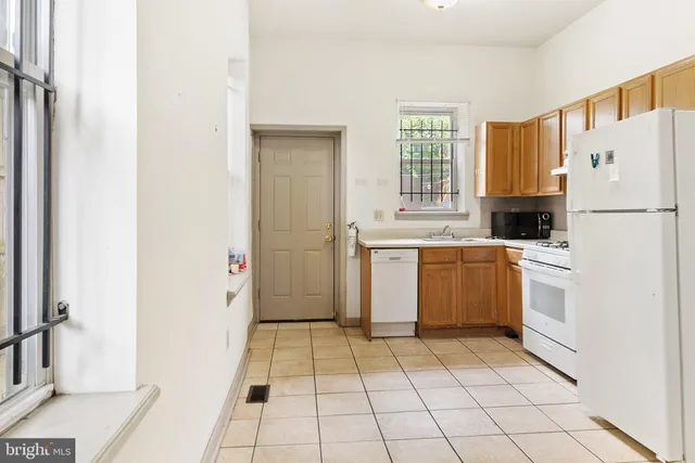 a kitchen with a refrigerator sink and cabinets