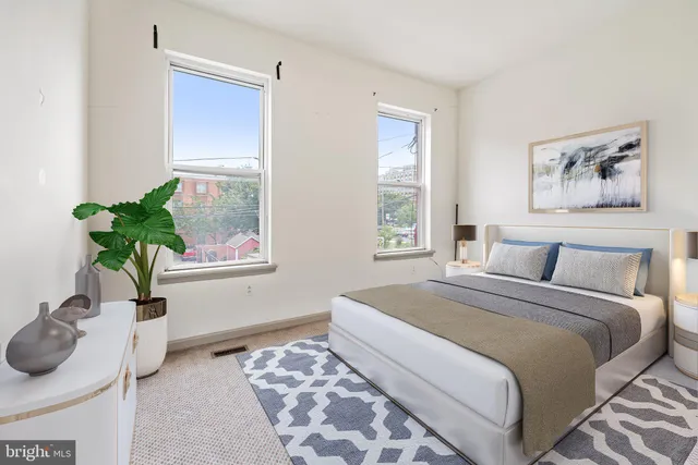 a bedroom with a bed and a window