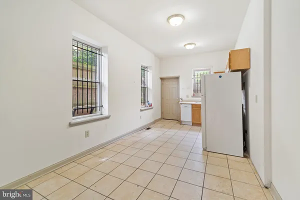 a view of a kitchen with a refrigerator cabinet and a refrigerator