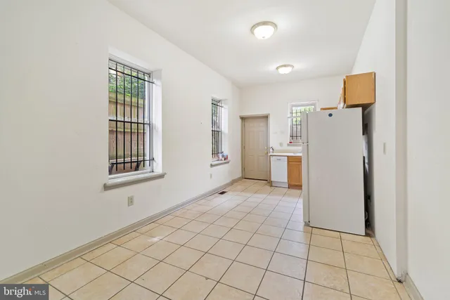 a view of a kitchen with a refrigerator cabinet and a refrigerator