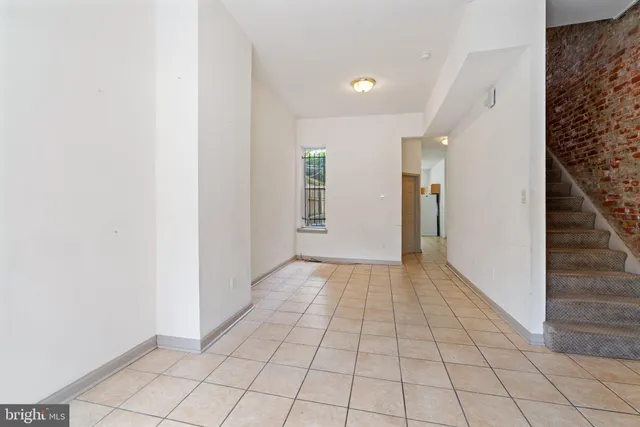 a view of an empty room and stairs