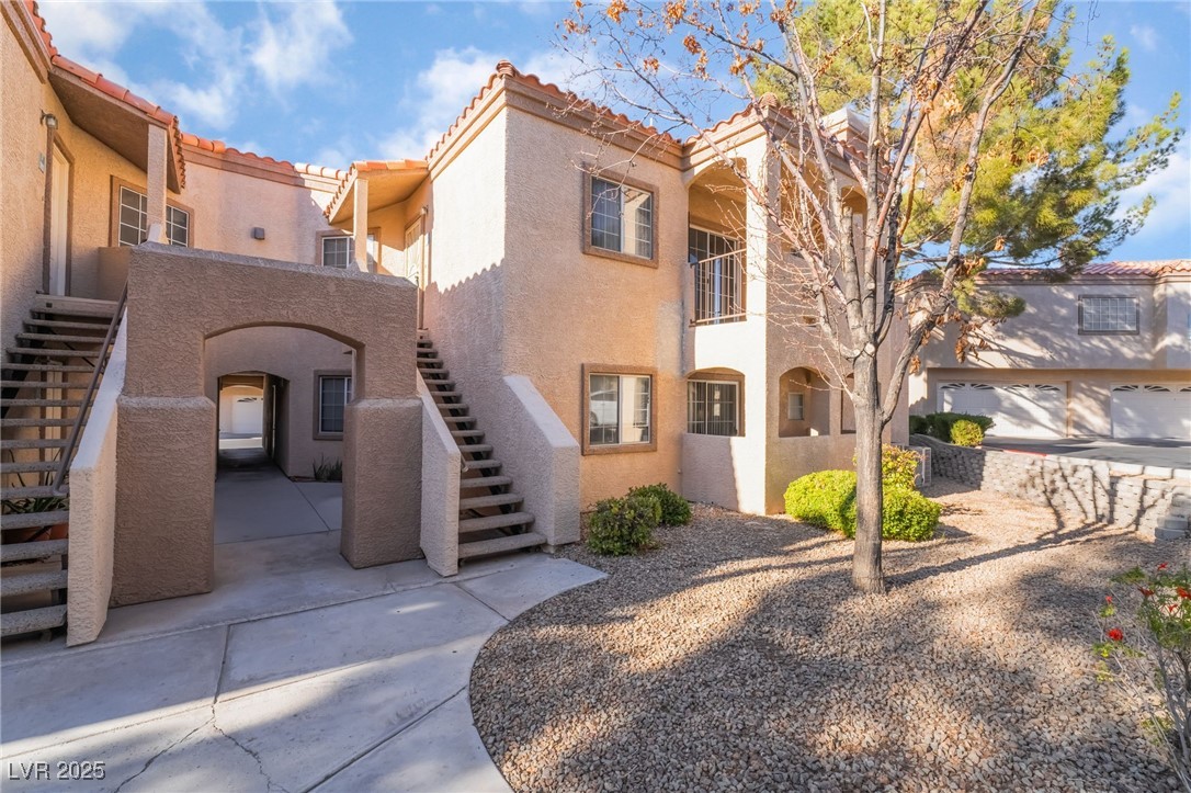 1851 Hillpointe Road, Unit 2912 Henderson, NV 89074 - Photo 1 of 28 View of front of home with stairs, a tile roof, and stucco siding