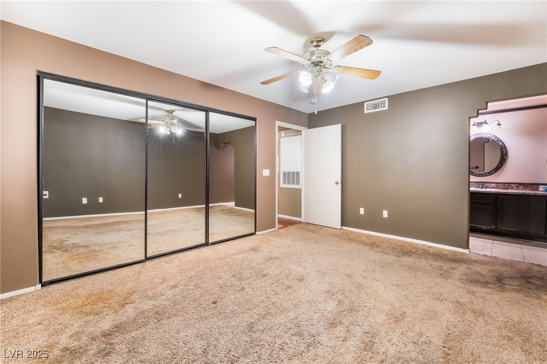 1851 Hillpointe Road, Unit 2912 Henderson, NV 89074 - Photo 12 of 28 Unfurnished bedroom featuring ceiling fan, baseboards, visible vents, and light colored carpet