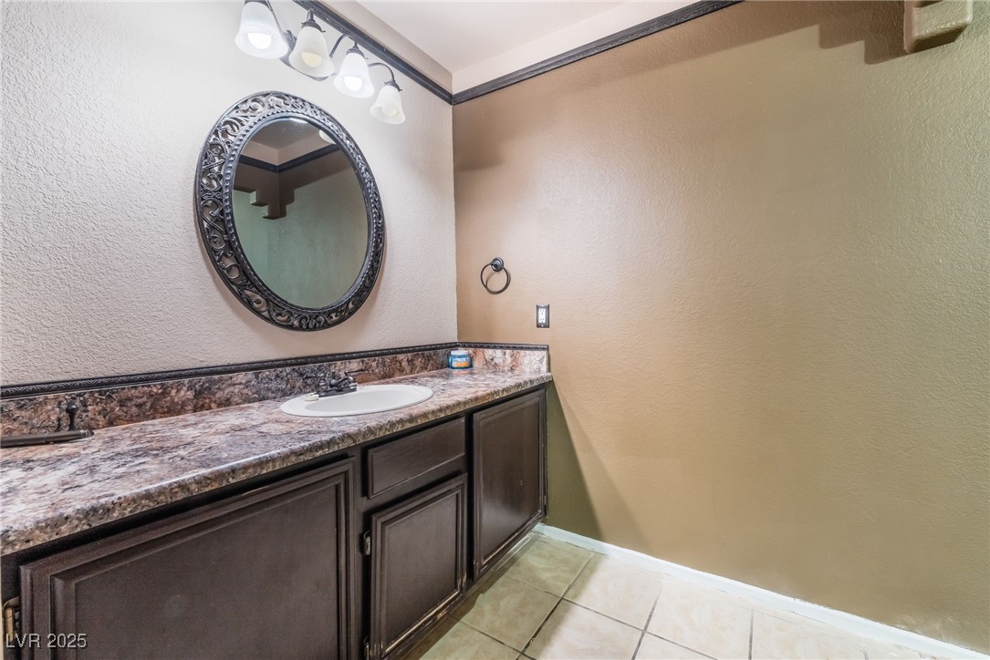 1851 Hillpointe Road, Unit 2912 Henderson, NV 89074 - Photo 15 of 28 Bathroom featuring baseboards, vanity, and tile patterned floors