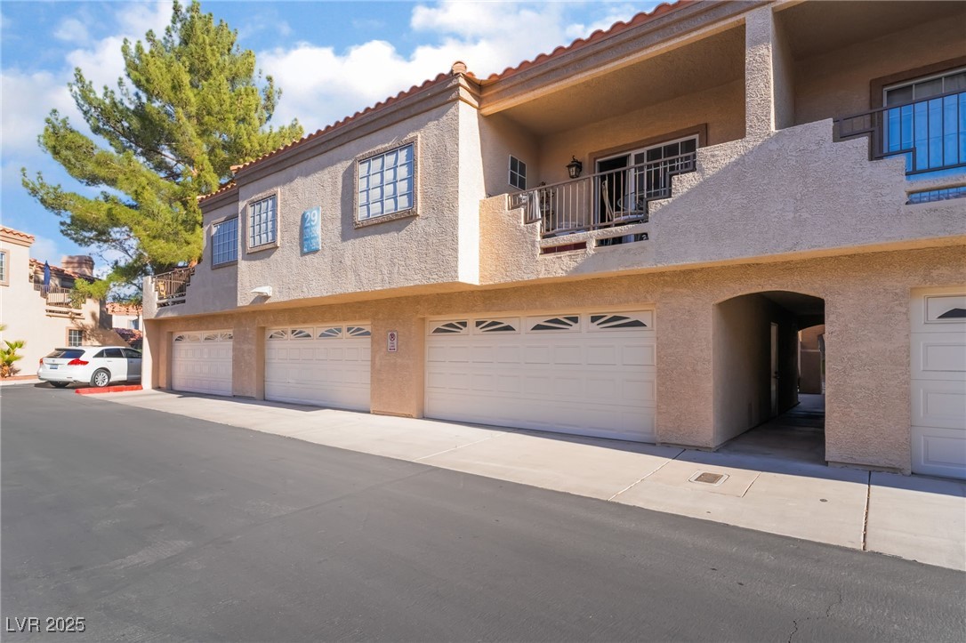 1851 Hillpointe Road, Unit 2912 Henderson, NV 89074 - Photo 4 of 28 View of front facade with an attached garage, a tiled roof, and stucco siding