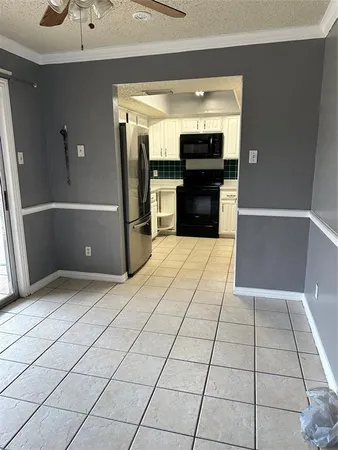 a view of kitchen with refrigerator and a stove