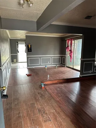 a view of a room with wooden floor