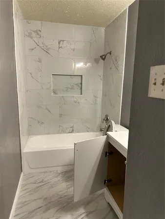 a bathroom with a bathtub and shower