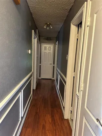 a view of hallway with wooden floor