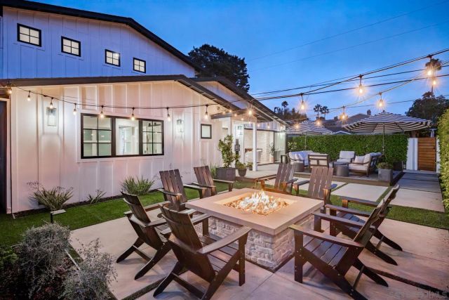 a backyard of a house with outdoor seating
