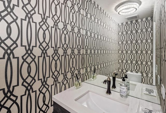 a bathroom with a sink mirror and vanity