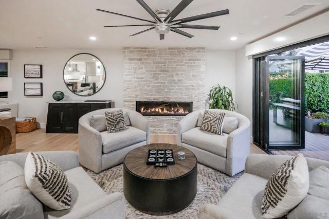 a living room with furniture a large window and a clock
