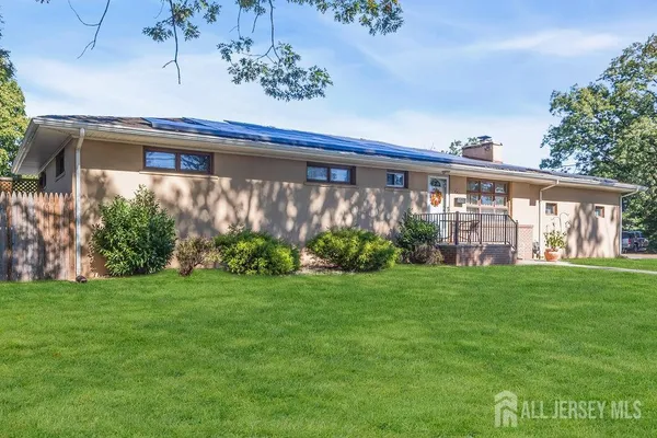 a front view of house with yard and green space