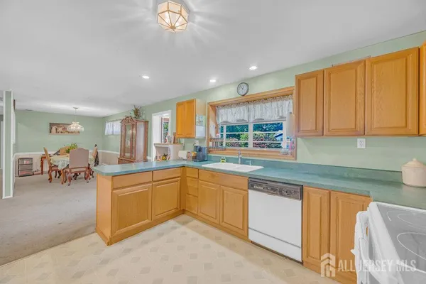 a kitchen with stainless steel appliances granite countertop sink stove and cabinets