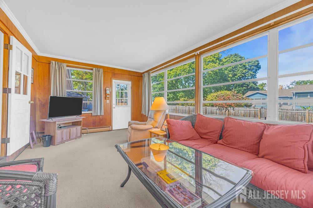 531 Chestnut Street Middlesex, NJ 08846 - Photo 20 of 42 a living room with furniture a flat screen tv and a floor to ceiling window