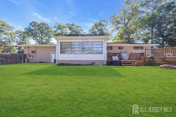 a view of a house with a backyard and a patio