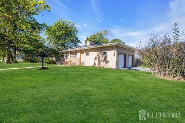 a view of an house with backyard space and garden