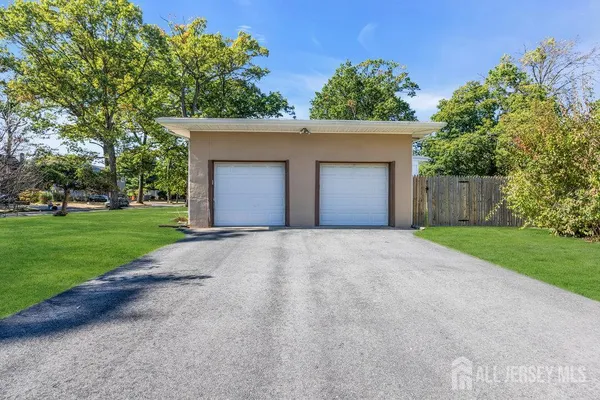 front view of a house with a yard and a garage