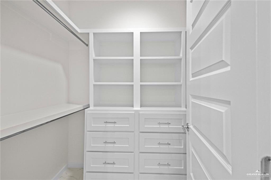 2737 East Conroe Road Edinburg, TX 78542 - Photo 12 of 14 a view of walk in closet with empty racks