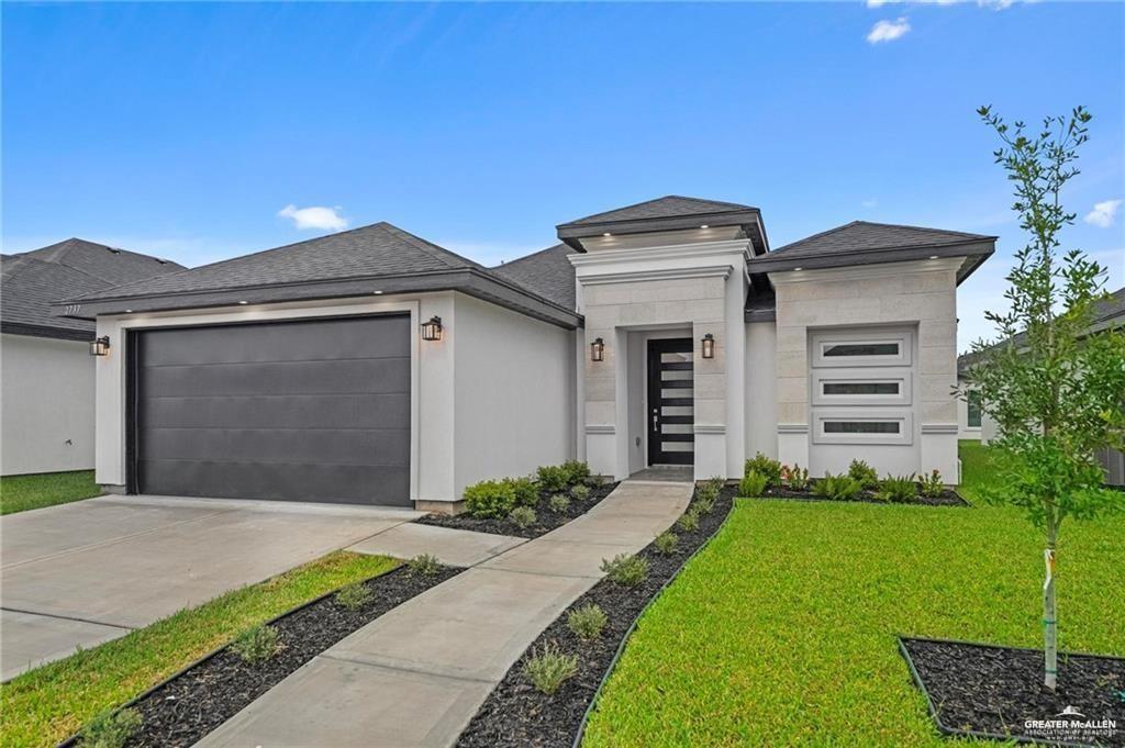 2737 East Conroe Road Edinburg, TX 78542 - Photo 2 of 14 a front view of a house with a garden