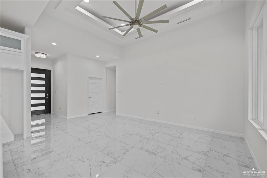 2737 East Conroe Road Edinburg, TX 78542 - Photo 4 of 14 an empty room with a ceiling fan and a window