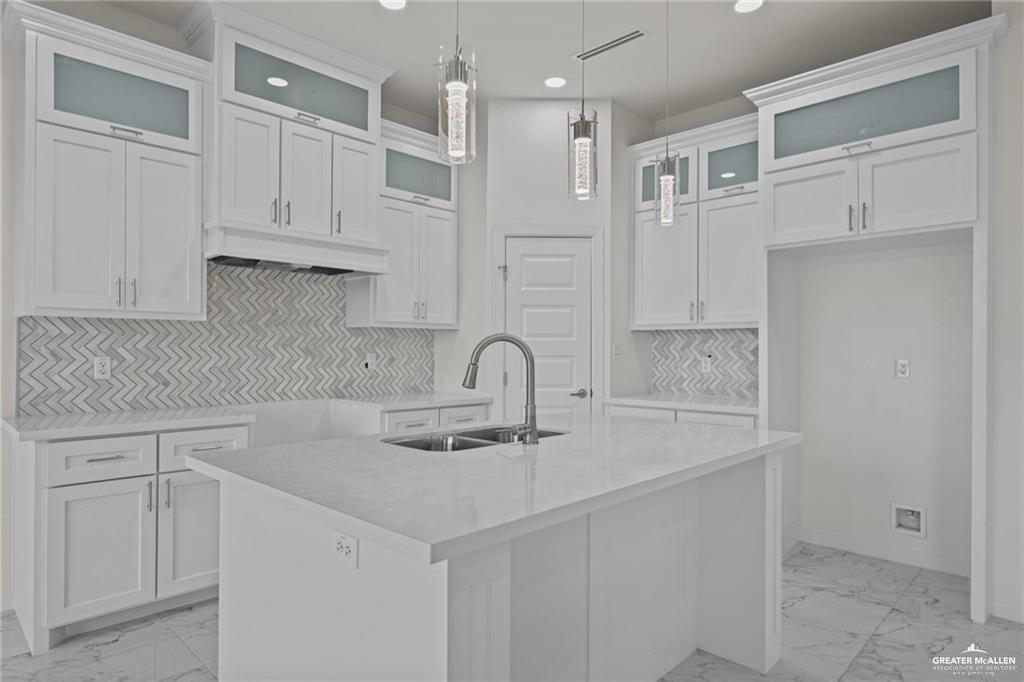 2737 East Conroe Road Edinburg, TX 78542 - Photo 5 of 14 a kitchen with white cabinets