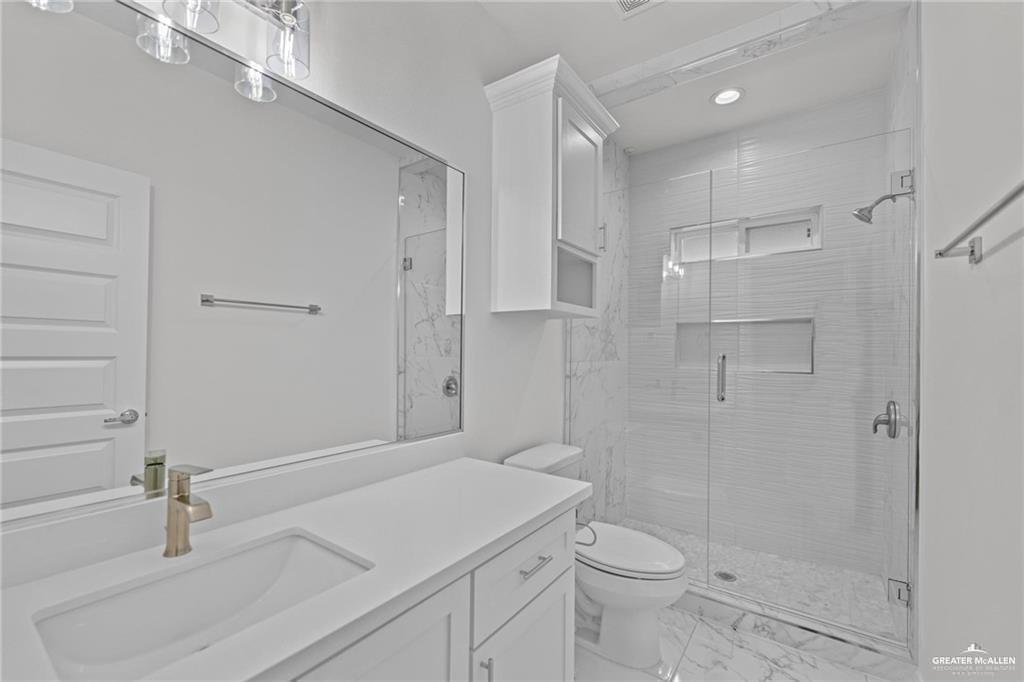2737 East Conroe Road Edinburg, TX 78542 - Photo 9 of 14 a bathroom with a sink toilet and shower