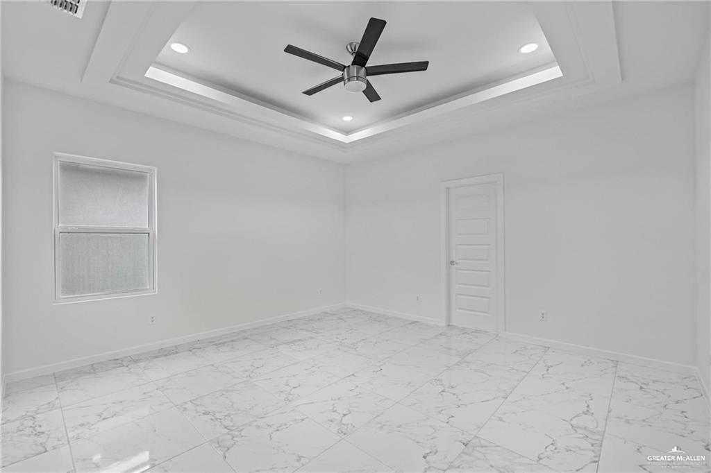 2737 East Conroe Road Edinburg, TX 78542 - Photo 10 of 14 an empty room with a ceiling fan and window