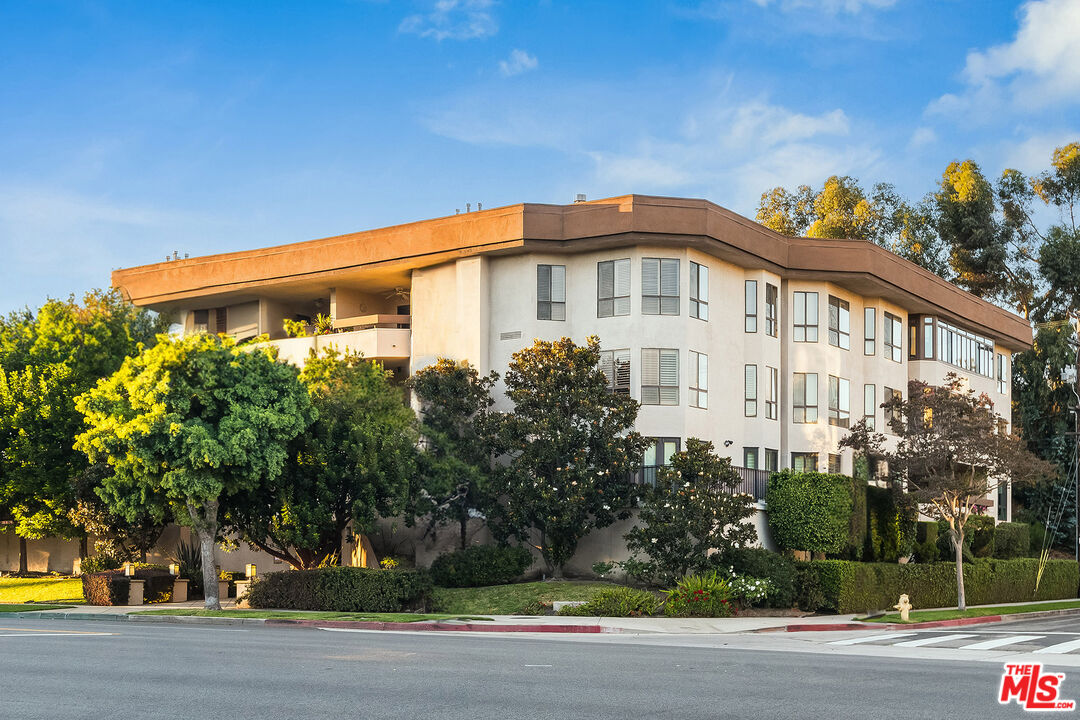10409 Riverside Drive, Unit 203 Toluca Lake, CA 91602 - Photo 1 of 34 a front view of a house with a yard