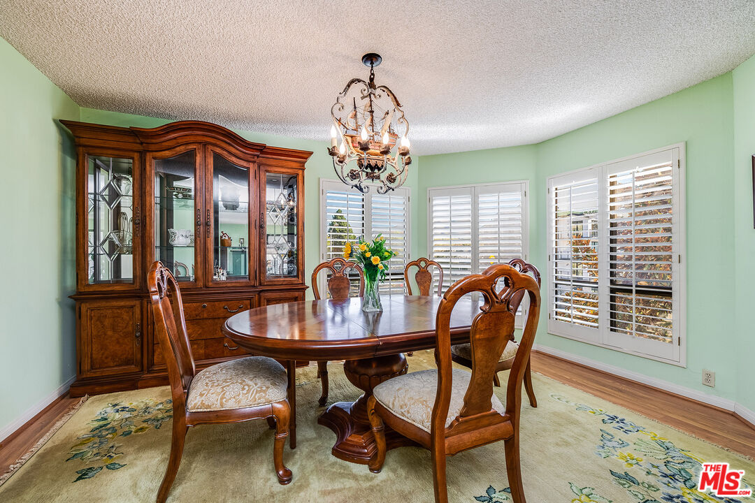 10409 Riverside Drive, Unit 203 Toluca Lake, CA 91602 - Photo 11 of 34 a view of a dining room with furniture window and wooden floor