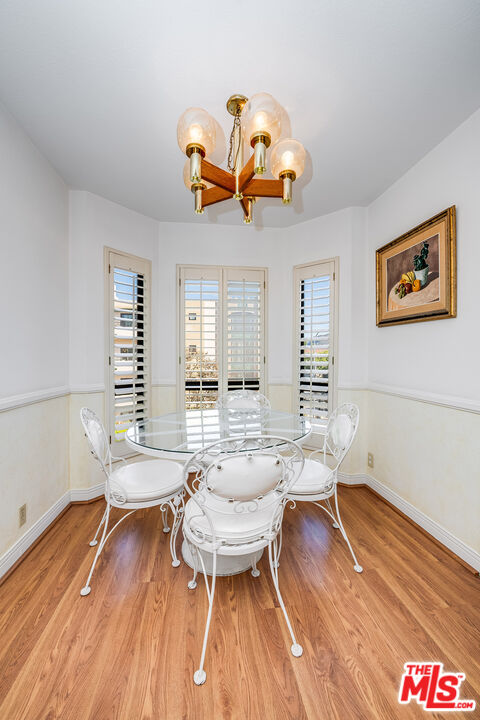 10409 Riverside Drive, Unit 203 Toluca Lake, CA 91602 - Photo 12 of 34 a living room with furniture and a wooden floor