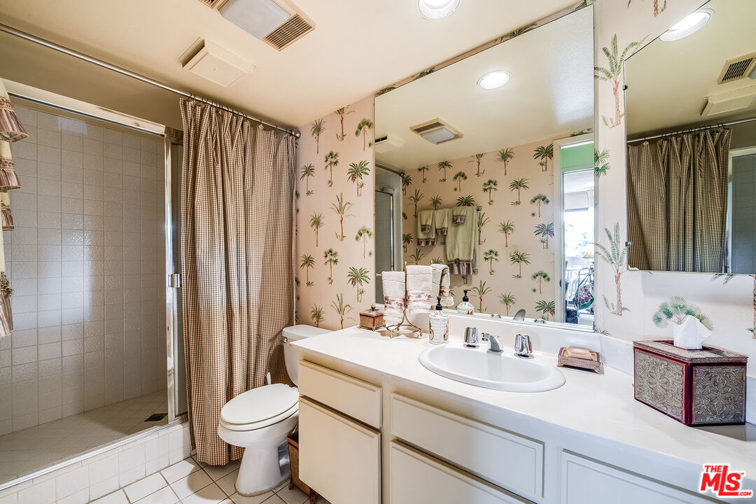 10409 Riverside Drive, Unit 203 Toluca Lake, CA 91602 - Photo 21 of 34 a bathroom with a sink a toilet and shower