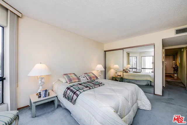 a bedroom with a bed and a lamp