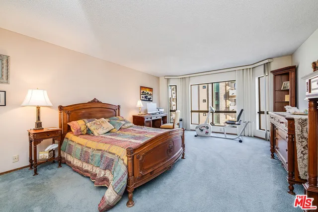 a bedroom with two beds and a dresser