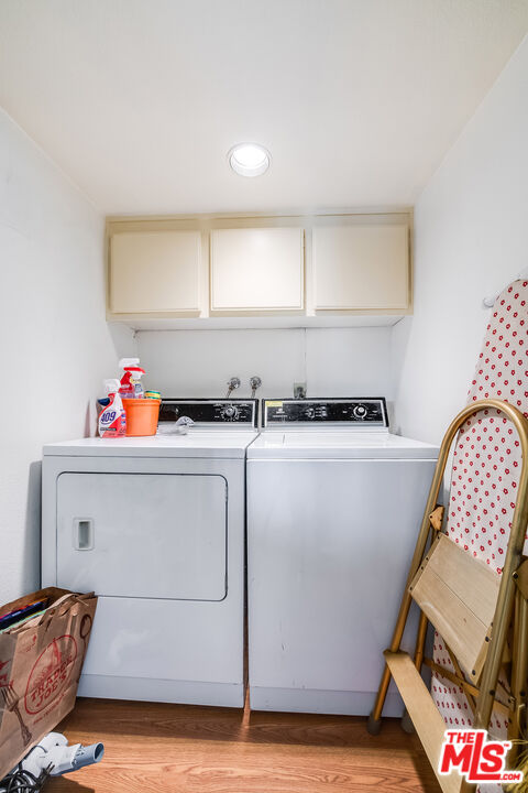 10409 Riverside Drive, Unit 203 Toluca Lake, CA 91602 - Photo 31 of 34 a utility room with cabinets dryer and washer