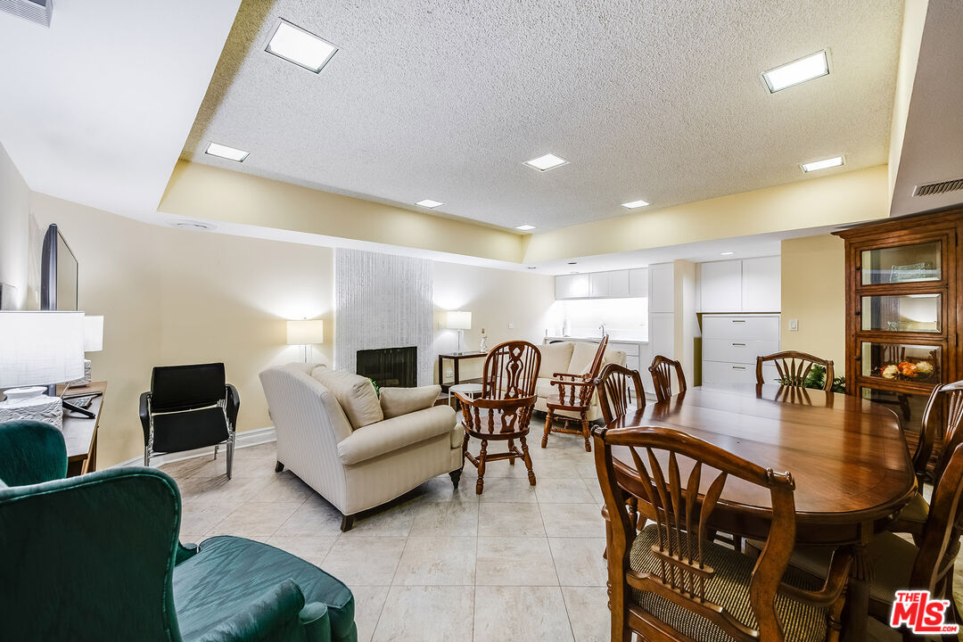 10409 Riverside Drive, Unit 203 Toluca Lake, CA 91602 - Photo 32 of 34 a living room with lots of furniture and kitchen view