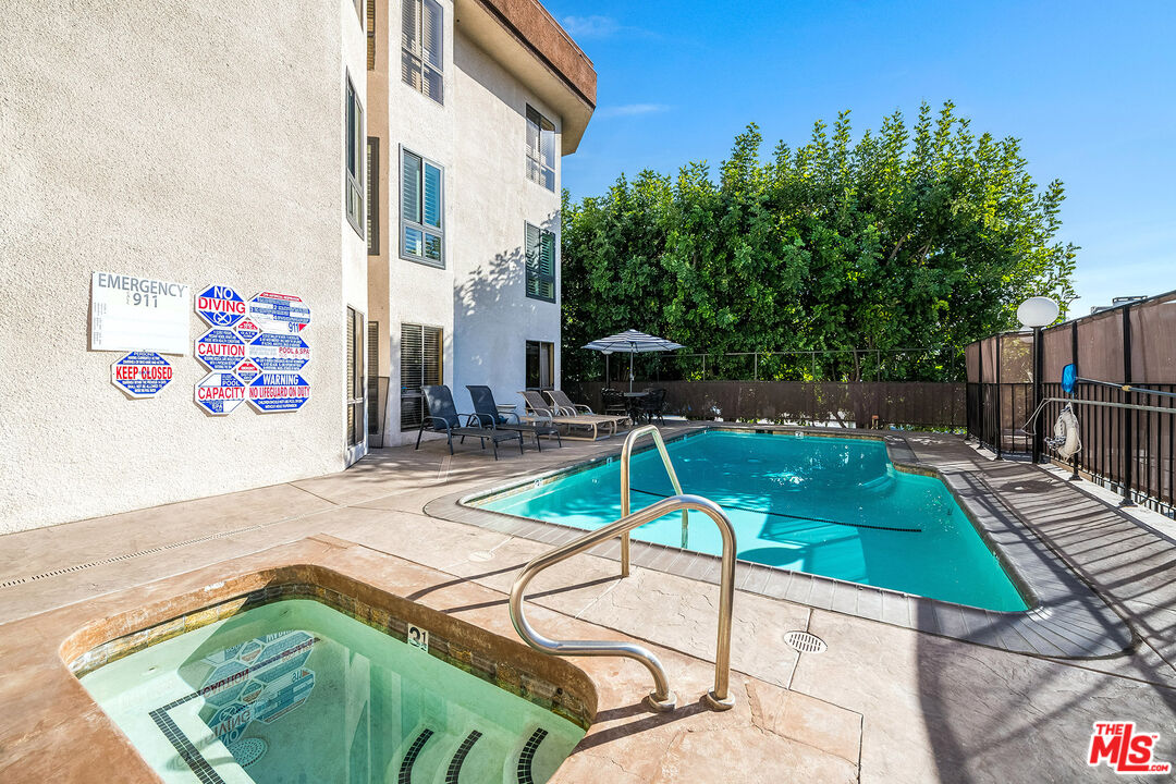 10409 Riverside Drive, Unit 203 Toluca Lake, CA 91602 - Photo 33 of 34 a view of a swimming pool with a patio