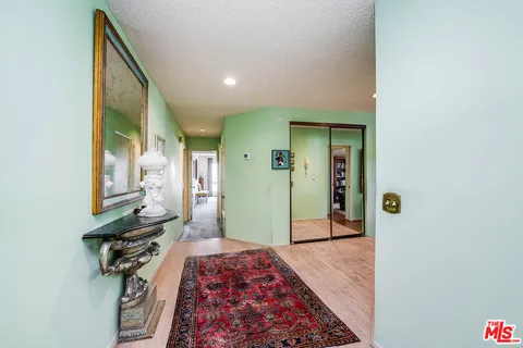 a bedroom with a bed and a mirror