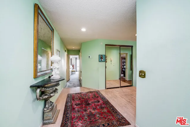 a bedroom with a bed and a mirror