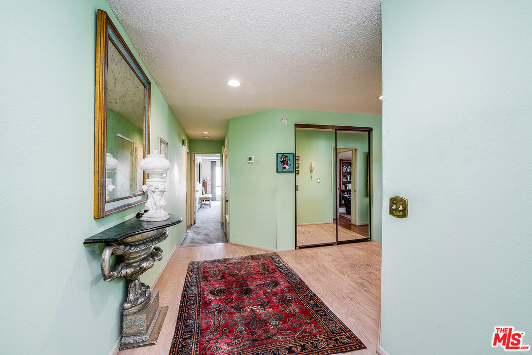 10409 Riverside Drive, Unit 203 Toluca Lake, CA 91602 - Photo 6 of 34 a bedroom with a bed and a mirror