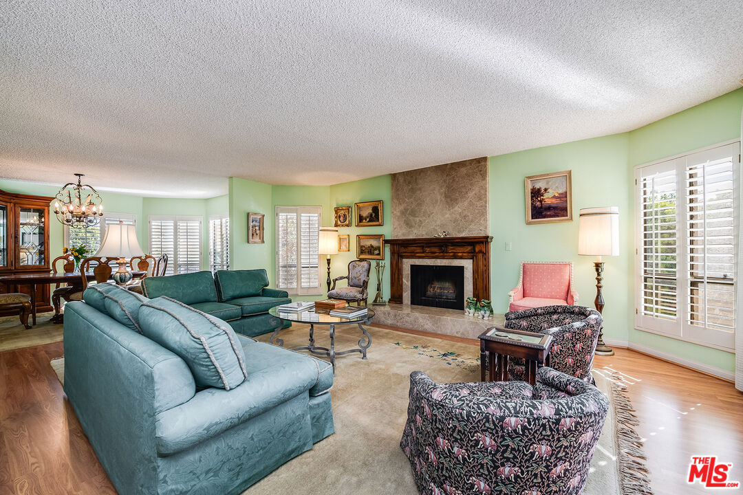 10409 Riverside Drive, Unit 203 Toluca Lake, CA 91602 - Photo 8 of 34 a living room with furniture a fireplace and wooden floor