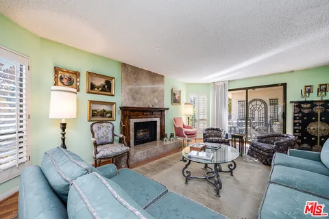 a living room with furniture fireplace and a table