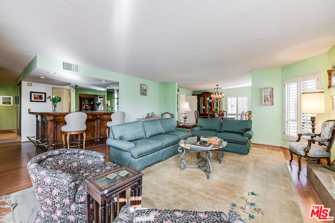 10409 Riverside Drive, Unit 203 Toluca Lake, CA 91602 - Photo 10 of 34 a living room with furniture and wooden floor