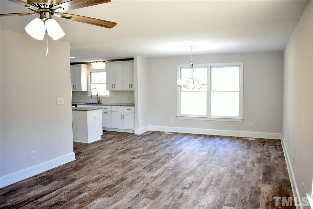 5500 Live Oak Trail Raleigh, NC 27613 - Photo 14 of 24 a view of an empty room with a window and wooden floor