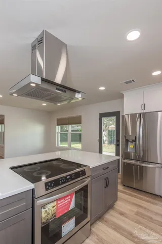 a kitchen with a stove and a refrigerator