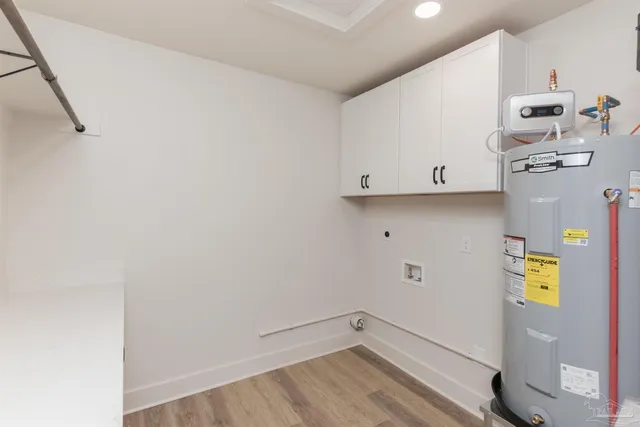 a view of storage and utility room with wooden floor