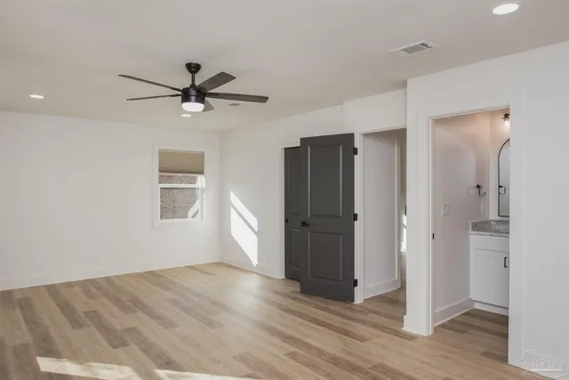 a bathroom with a granite countertop sink a toilet and a mirror